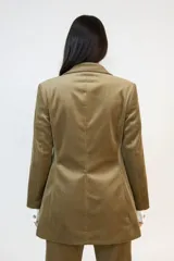 Blazer de pana color marrón con solapas clásicas, cierre frontal con botones y bolsillos con solapa. Presenta un corte entallado y estructura formal.