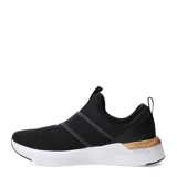 Championes Puma Softride Harli Slip On, color negro con suela blanca y detalles en color bronce. Diseño sin cordones con bandas elásticas cruzadas, capellada textil transpirable y amortiguación confortable.