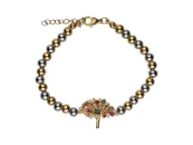 Pulsera de acero con baño de oro, con cuentas plateadas y doradas. Dije central de árbol de la vida con incrustaciones de piedras de colores.