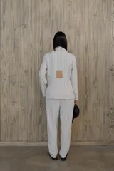Pantalón de vestir de corte recto y tiro medio con diseño de raya diplomática. Confeccionado en tela liviana con caída fluida.