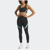 Calza deportiva de tiro alto color negro con detalles curvos en color turquesa y paneles de malla en los laterales. Confeccionada en tejido elástico de alta compresión.