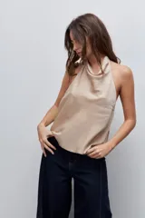 Top negro de cuello drapeado con diseño de espalda descubierta y calce fluido.