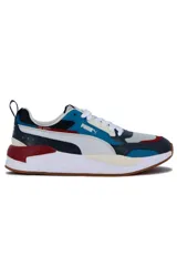 Championes deportivos Puma X-Ray en combinación de azul, gris y negro, con detalles en amarillo flúor y suela blanca y azul.