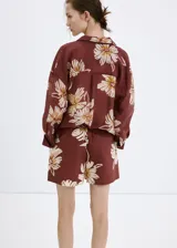 Short marrón con estampado floral grande en tonos beige y blanco, de tiro regular y silueta relajada con cintura elástica.