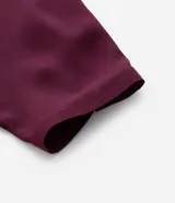 Blusa tipo bata de crepé color bordó, con cuello redondo, detalle de escote en V y mangas 3/4 con fruncidos.