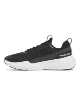 Championes de entrenamiento Under Armour Project Rock BSR 5, color negro con suela blanca. Presentan una parte superior de malla transpirable con refuerzos sintéticos, mediasuela Charged Cushioning para amortiguación reactiva y tecnología UA TriBase para mayor estabilidad y contacto con el suelo.