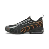 Championes Puma modelo Voltra, de diseño deportivo con tecnología X-CELL en la suela. Presentan una base de malla negra con detalles superpuestos en gris y naranja, incluyendo el logo de la marca en el frente.