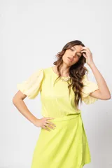 Blusa verde con cuello redondo y mangas cortas abullonadas.