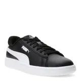 Championes Puma modelo Smash 3.0 Leather, color negro con la icónica franja lateral en blanco. Presentan un diseño de corte bajo, cierre con cordones y suela de goma blanca.