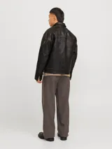 Campera de cuero marrón con cuello biker y cierre con cremallera. Confeccionada en cuero de cabra suave, naturalmente resistente al agua. Presenta mangas largas y bolsillos frontales con cierre de botón.