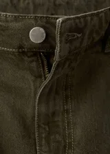 Pantalón de jean estilo barrel de tiro bajo, con diseño de cinco bolsillos, cierre frontal de cremallera y botón, y trabillas para cinturón.