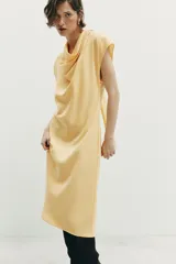Vestido midi de corte evasé confeccionado en mezcla de modal, con cuello fluido tipo drapeado, manga sisa caída y abertura en la espalda.