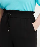 Pantalón pantalona negro de crepé con cintura elástica ajustable con lazo, bolsillos laterales y corte amplio.
