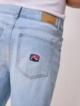 Bermuda de jean celeste con roturas y terminación desflecada.