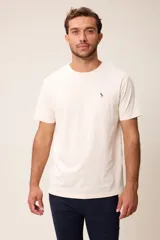 Remera básica de manga corta con cuello redondo y corte regular fit. Presenta un pequeño bordado en el pecho.