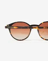 Gafas de sol unisex Hawkers X Pierre Gasly, con montura redonda carey y lentes marrones degradadas.