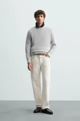 Sweater de punto color beige con textura tipo waffle, cuello redondo y mangas largas con acabado en rib.