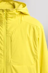 Chaqueta acolchada Zara Athleticz de color amarillo, confeccionada en tejido técnico y ligero. Cuenta con cuello subido y capucha, manga larga con puños elásticos, bolsillos frontales con cierre de cremallera oculta y cierre frontal con cremallera.