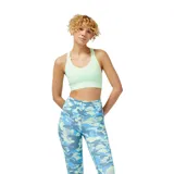 Top deportivo New Balance Pace Bra color verde claro, con espalda deportiva y banda inferior elástica con logo de la marca.