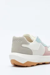 Zapatilla urbana de diseño contemporáneo con capellada que combina paneles de diferentes texturas en color negro, ajuste con cordones y suela robusta de color blanco.