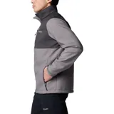 Chaqueta Columbia Ascender Soft Shell con diseño bicolor en tonos gris y gris oscuro. Cuenta con cierre frontal completo, cuello alto con protector de mentón, bolsillo en el pecho con cierre, bolsillos laterales con cierre y puños ajustables con velcro.