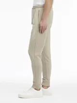 Pantalón de jogging color beige, de corte regular, con cintura elástica ajustable con cordones, bolsillos laterales, pierna cónica con puños elásticos y logo de Calvin Klein bordado.
