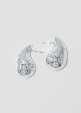 Par de aros plateados con forma de gota y strass incrustados.