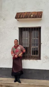 Falda midi de seda con estampado de lunares pequeños, corte recto y terminación con detalle de encaje negro en el ruedo.
