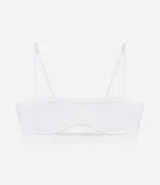 Soutien tipo top, color blanco, confeccionado en tejido seamless de poliamida y elastano. Presenta tirantes finos ajustables y un ribete contorneado bajo el busto.