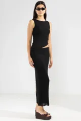 Top negro sin mangas con detalle de abertura en la cintura. Hecho en Italia.