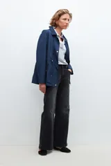 Campera impermeable azul marino con capucha desmontable, cierre frontal con botones a presión y cordón ajustable en la cintura.
