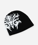 Gorro tipo beanie reversible de punto, con diseño tribal abstracto en contraste blanco y negro. Confeccionado en tejido de acrílico suave, ofrece aislamiento térmico y un ajuste cómodo.