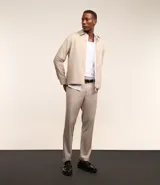 Pantalón de vestir color beige con estampa de cuadros en hilo teñido, corte slim, cintura con trabillas, cierre con botón y cremallera, bolsillos laterales y traseros.