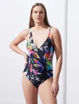 Malla enteriza negra con estampado de hojas de colores, escote en V cruzado y breteles regulables.