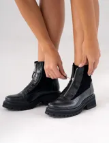 Botas cortas de cuero vacuno con textura de reptil, diseño con cierre frontal y suela de plataforma dentada de caucho.