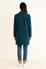 Tapado de corte recto y largo medio, confeccionado en tejido texturizado color gris. Presenta solapas clásicas, cierre frontal de un solo botón y mangas largas.