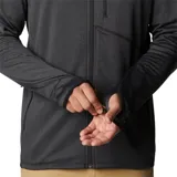 Campera de polar Columbia color gris oscuro, con cierre frontal completo, cuello alto, bolsillos laterales con cierre y bolsillo vertical con cierre en el pecho. Logo de la marca bordado en el pecho.