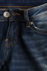 Jean de corte acampanado y tiro ultra bajo en denim azul oscuro con efecto desteñido y leve elasticidad.