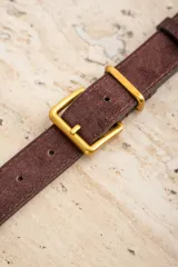 Cinto marrón de gamuza con hebilla cuadrada dorada.