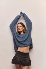 Buzo tejido color borgoña con cuello redondo y diseño de trenzas verticales.