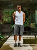 Bermuda de algodón rústico lavado color gris oscuro, con cordón ajustable en la cintura y pequeño bordado en el frente.