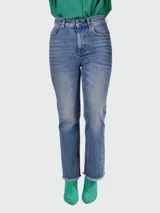 Pantalón de jean celeste con pierna acampanada y detalles desgastados.