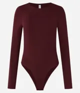 Body de manga larga y cuello redondo, confeccionado en poliamida con elastano. Presenta un diseño liso, ajustado al cuerpo y cierre en la entrepierna.