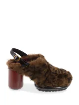 Sueco negro con pelo sintético, taco de madera y hebilla trasera para ajustar al talón.