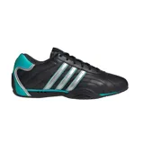 Championes Adidas Adiracer de perfil bajo inspirados en el automovilismo, en color negro con detalles plateados y turquesa. Presentan diseño de tres tiras en los laterales, empeine de cuero con inserciones sintéticas y suela de goma.