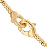 Pulsera de esferas pequeñas bañada en oro de 18k con cierre de mosquetón entrelazado.