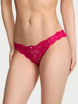 Bombacha tipo bikini confeccionada en encaje supersuave y elástico color fucsia, con tiro medio, detalle de pequeña roseta frontal y cobertura moderada en la espalda.