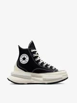 Championes de caña alta Converse Run Star Legacy CX, con diseño de plataforma irregular y voluminosa. Presentan cuerpo de lona negra con costuras blancas a contratono, cordones de algodón y el icónico parche de estrella en el lateral.