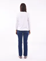 Remera de manga larga color beige, con cuello redondo y estampado frontal que dice "Magic is something you make" en color lila.