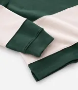 Chomba de manga larga con cuello polo y cierre frontal con botones. Presenta un diseño de rayas horizontales anchas en bloques de color verde y beige. Confeccionada en tejido de algodón de alta calidad.